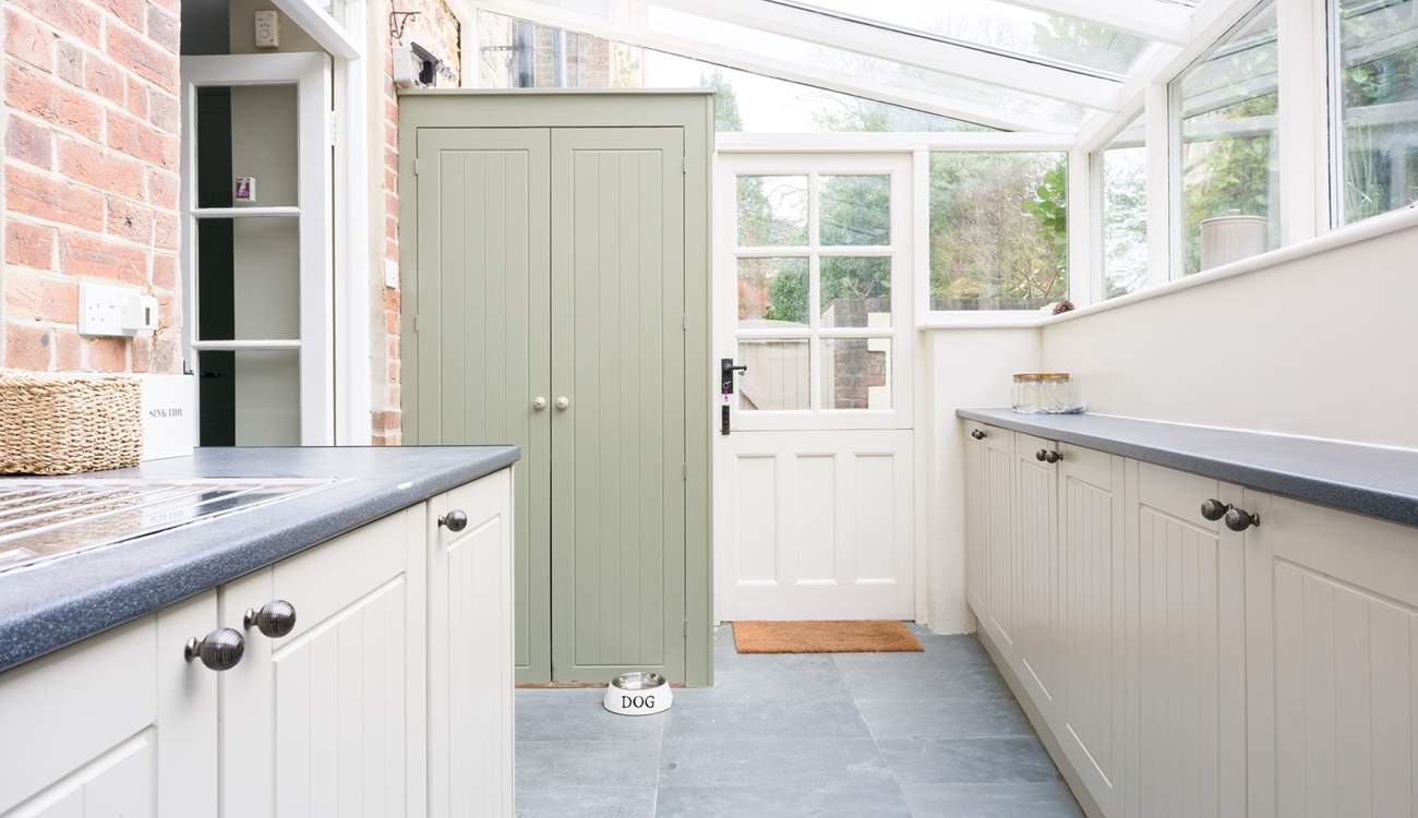 Completing the kitchen-area is this spacious utility/boot-room with washing machine, sink and plenty of storage.