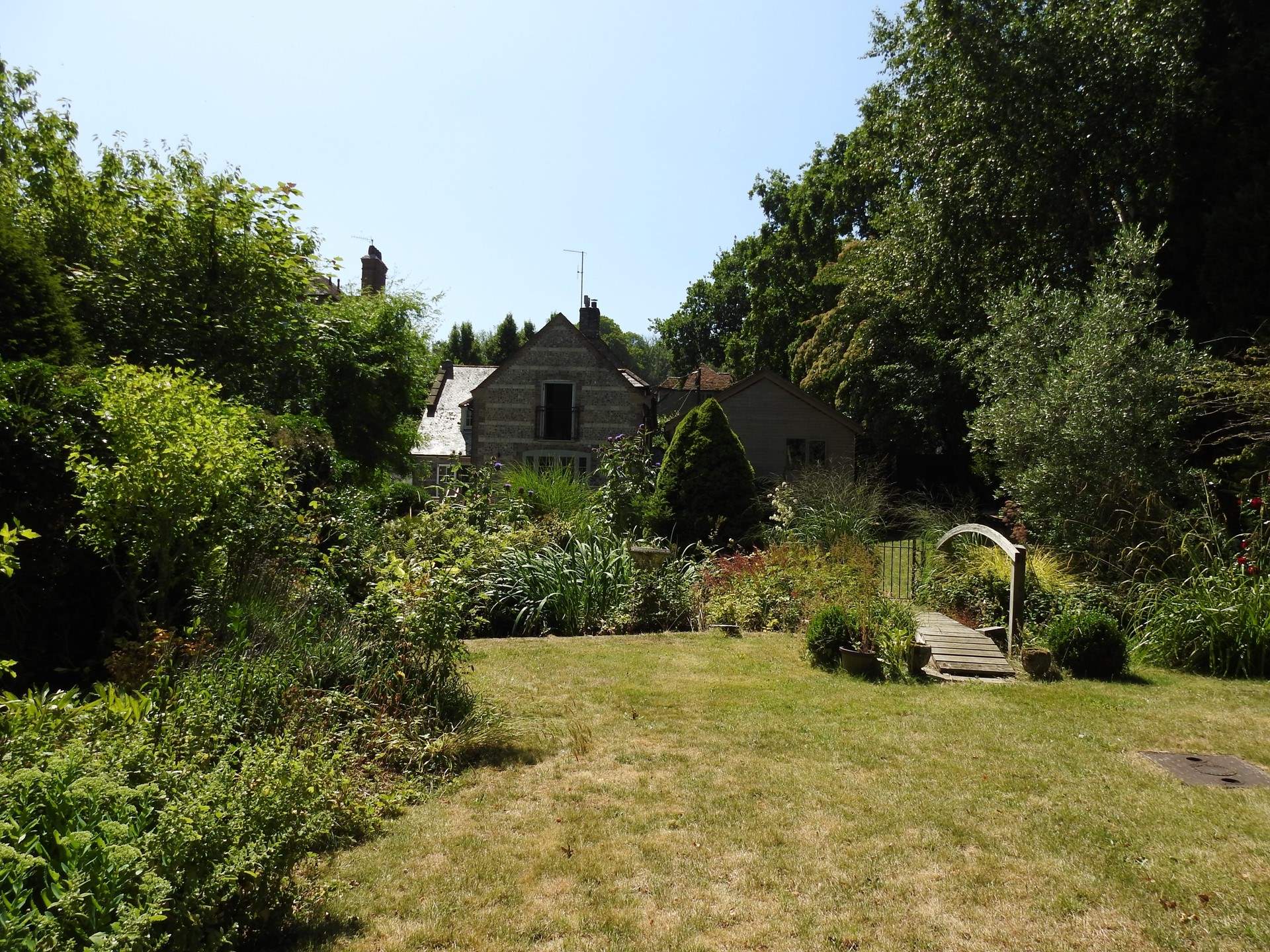 The gently landscaped gardens are a delight. Note that the top section of the garden can be enclosed and secured from the little pond.