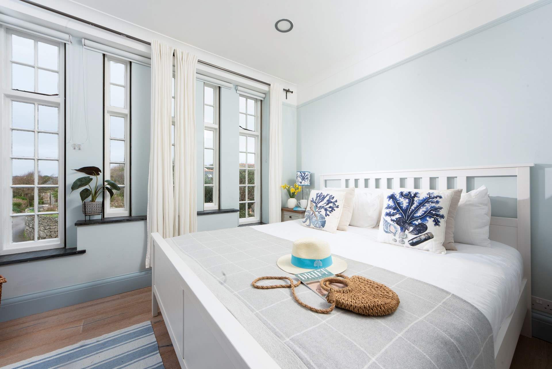 Large windows flood bedroom 1 with natural light.