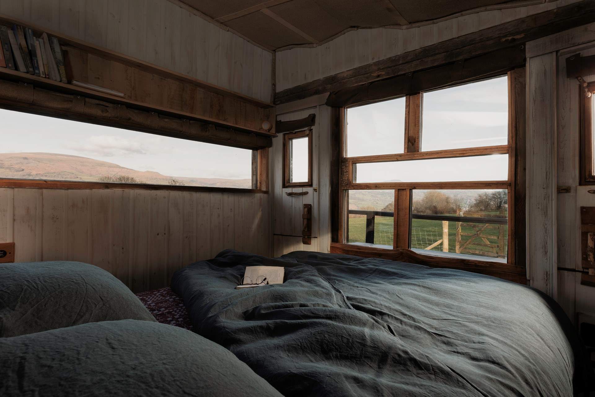 Wake slowly as the first light spills across the hills, enjoying the sunrise from the comfort of your bed.