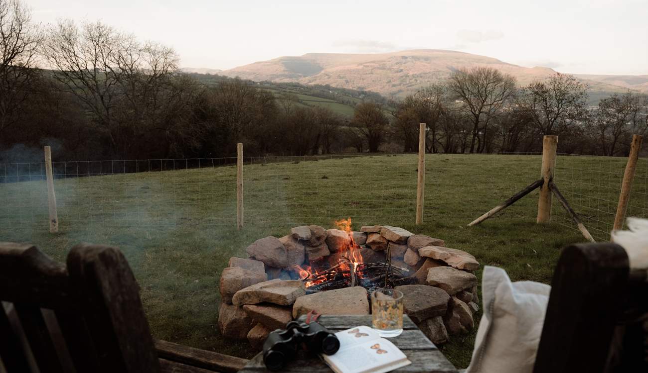 As evening settles, gather around the fire pit, watching the sun melt gently behind the hills.