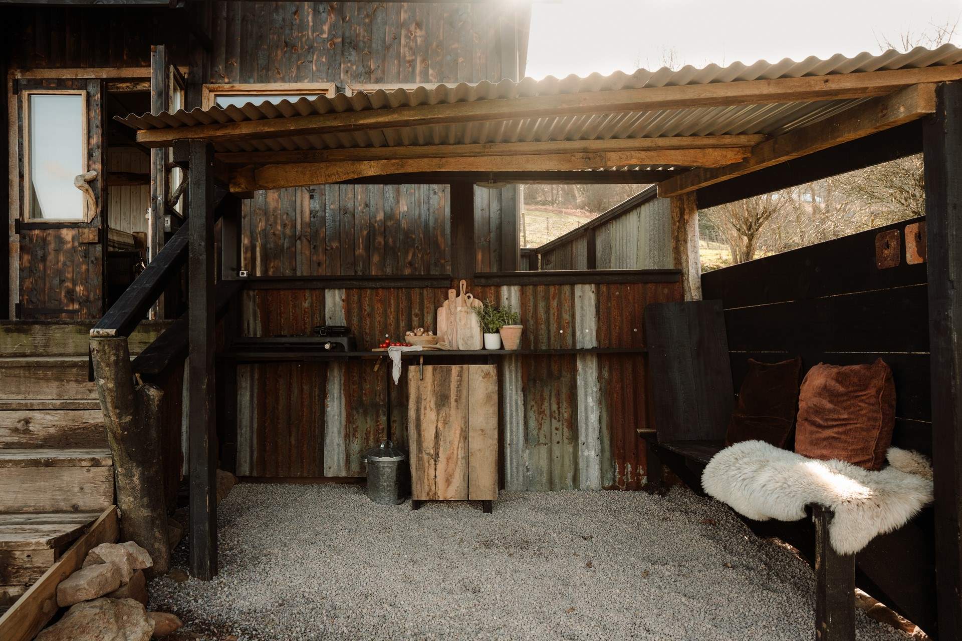 Follow the steps down to the sheltered alfresco kitchen for a dose of outdoor cooking.