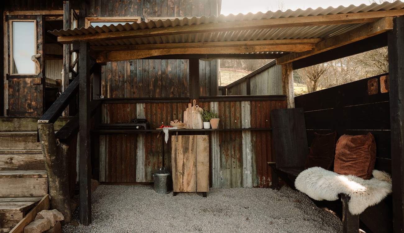 Follow the steps down to the sheltered al fresco kitchen for a dose of outdoor cooking.