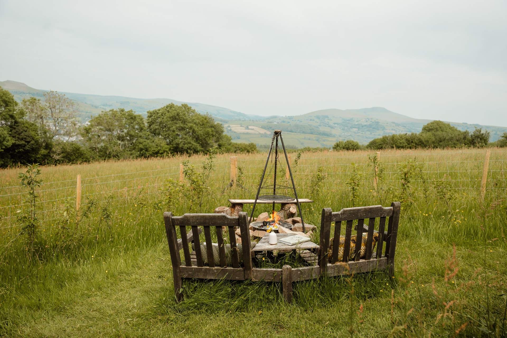 As evening settles, gather around the fire pit, watching the sun melt gently behind the hills.