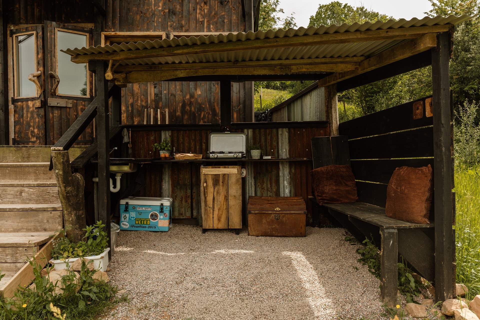 Follow the steps down to the sheltered al fresco kitchen for a dose of outdoor cooking.