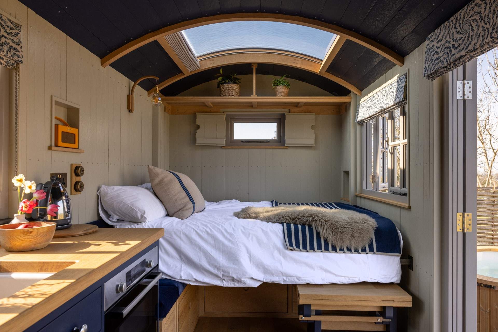 The space transforms with a fold-down bed and a comfortable mattress, complete with luxury linens for restful sleep.