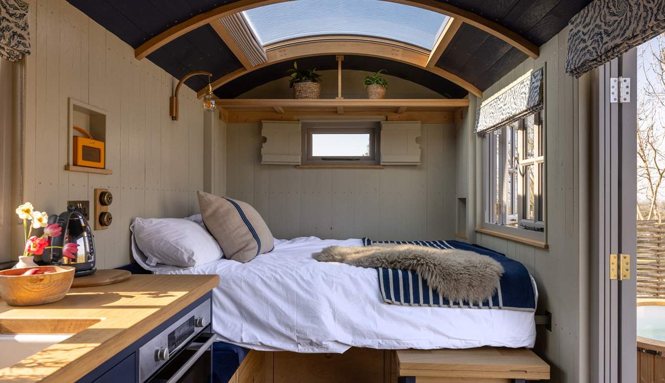 The space transforms with a fold-down bed and a comfortable mattress, complete with luxury linens for restful sleep.