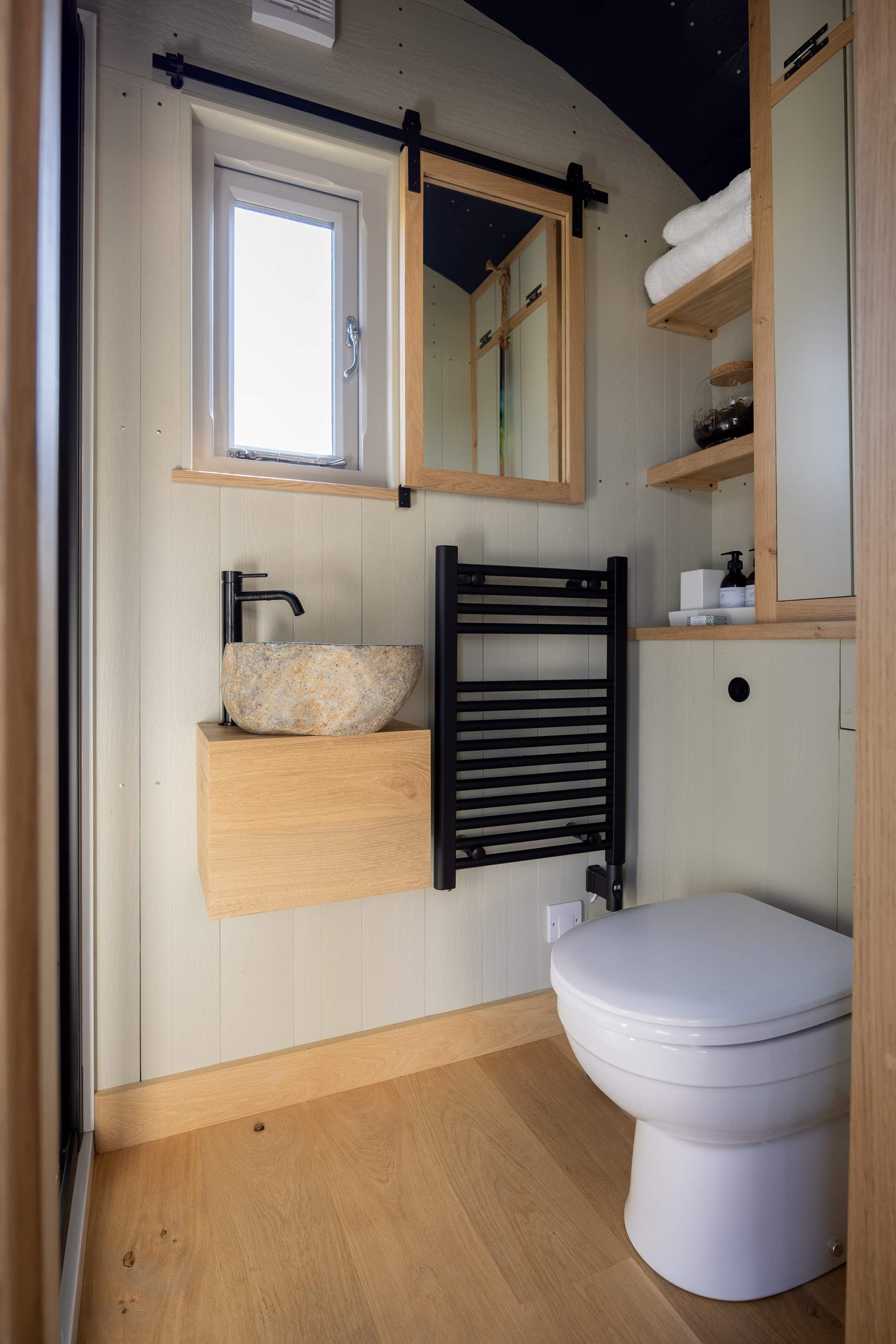 You'll find the sleek bathroom just beyond the kitchen.