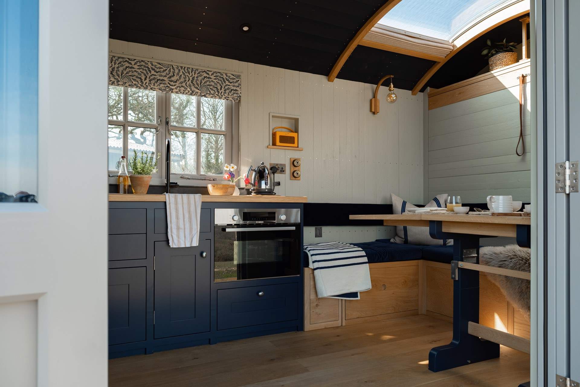 The fold-down table and seating area provide the perfect spot for slow breakfasts or relaxed evening meals.