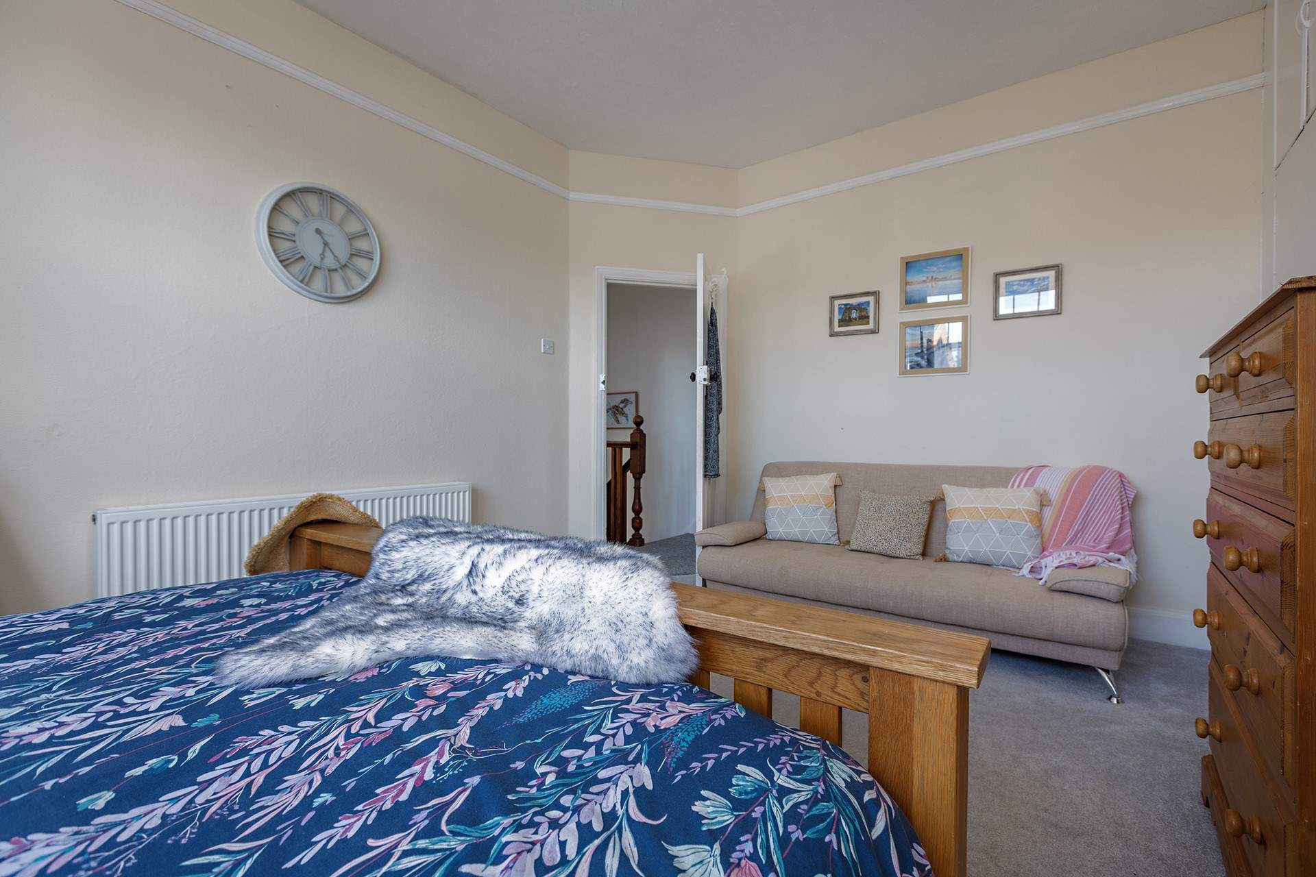 The spacious principal bedroom with king-size bed and a comfy sofa too!