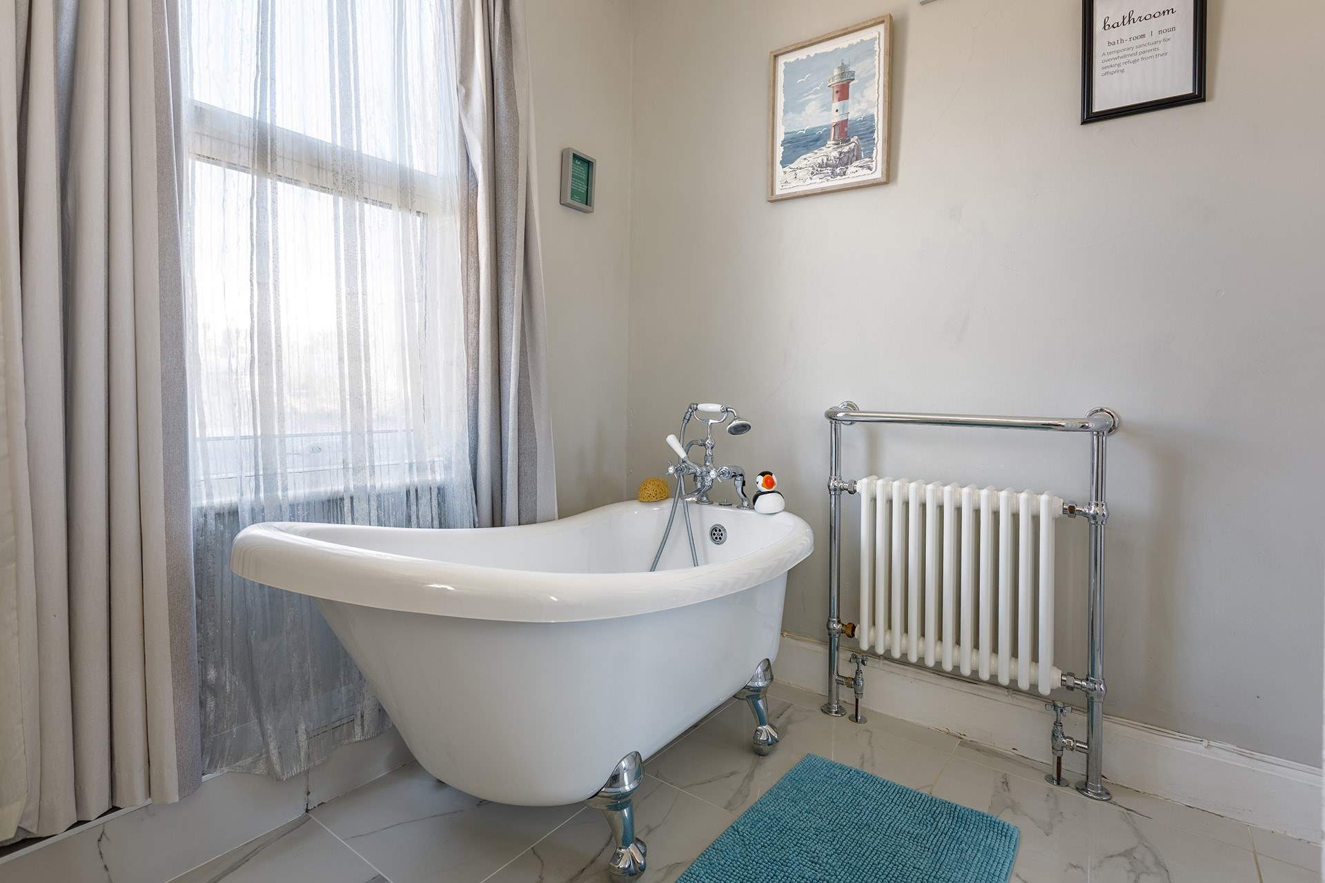 Enjoy the bubbles in the luxury slipper bath in the family bathroom.