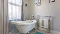 Enjoy the bubbles in the luxury slipper bath in the family bathroom.