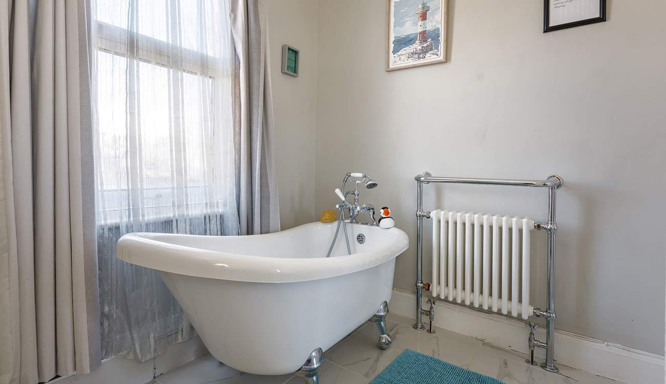 Enjoy the bubbles in the luxury slipper bath in the family bathroom.