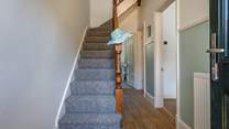 Climb the stairs to the bedrooms and family bathroom at this seaside escape.