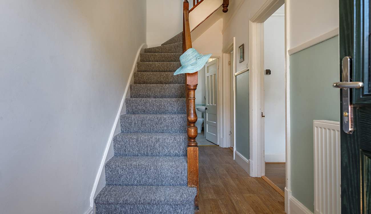 Climb the stairs to the bedrooms and family bathroom at this seaside escape.
