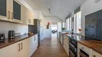 The spacious kitchen looks through to the open plan living/dining area; perfect for chatter with loved ones.