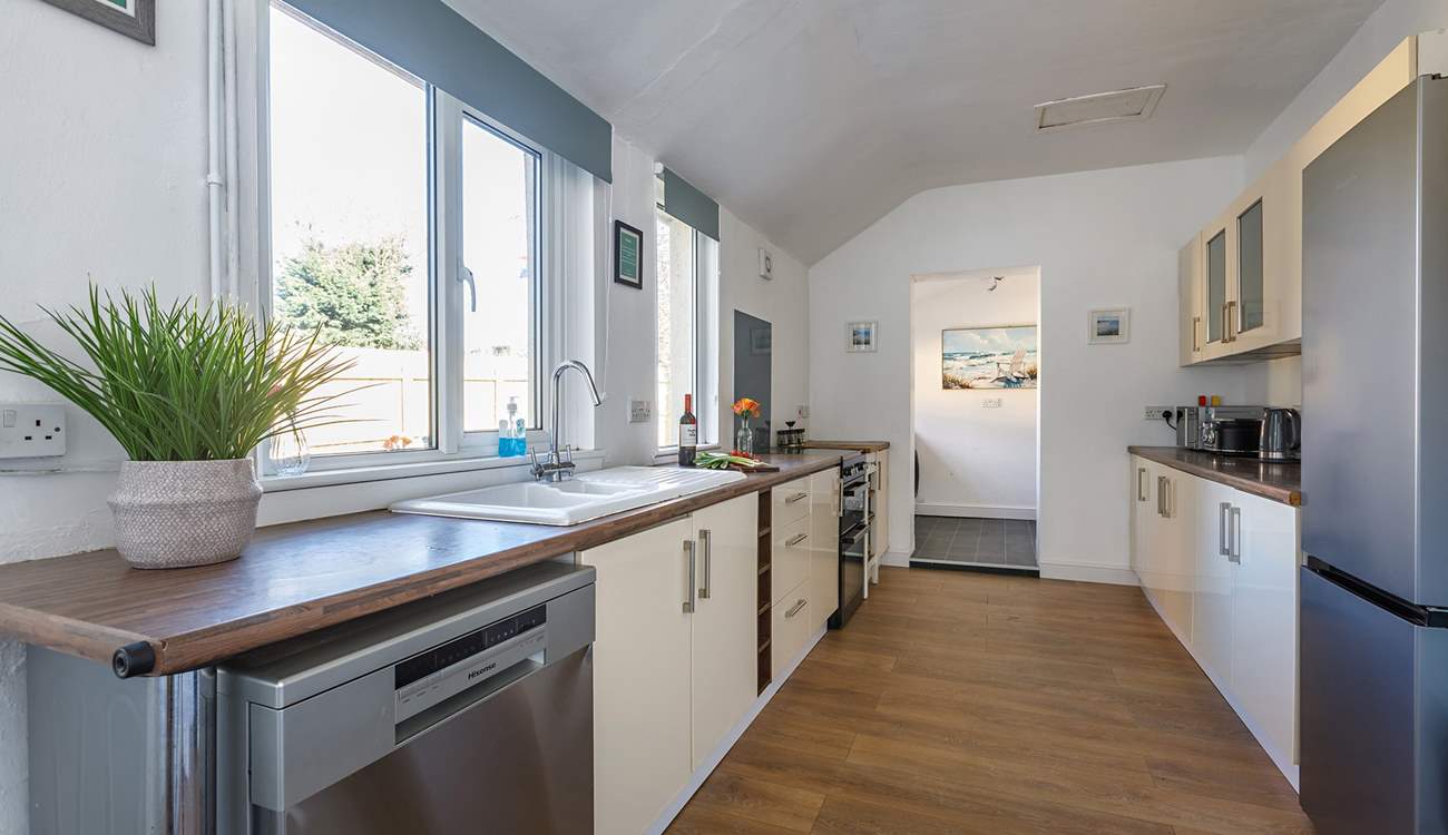 The dishwasher will handle the washing up with ease, plus there's a handy utility tucked away at the end of the kitchen.