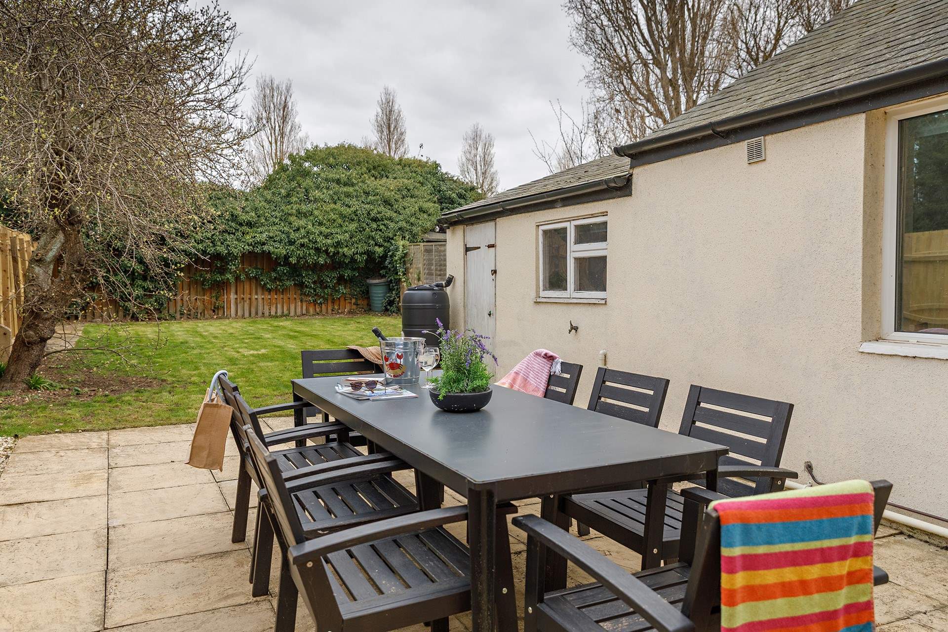 The enclosed garden is ideal for al fresco dining with welcome shade on warmer days under the apple tree.