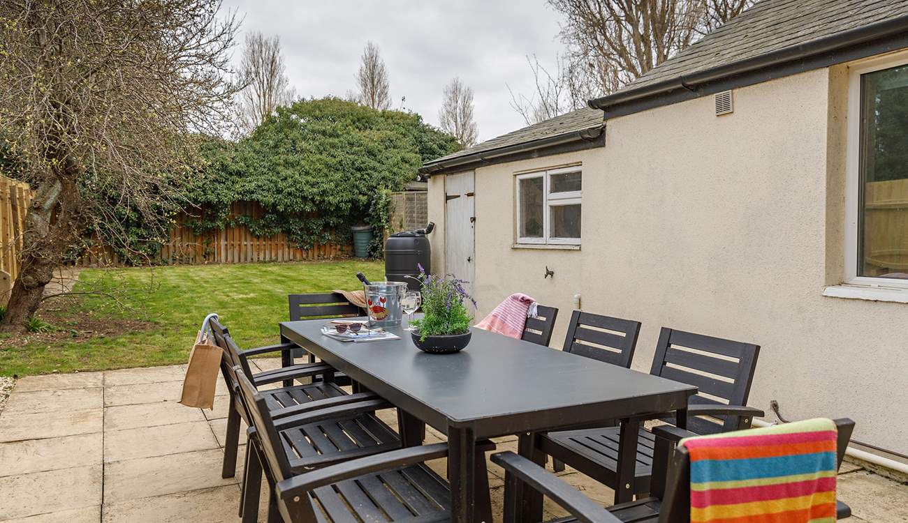 The enclosed garden is ideal for al fresco dining with welcome shade on warmer days under the apple tree.