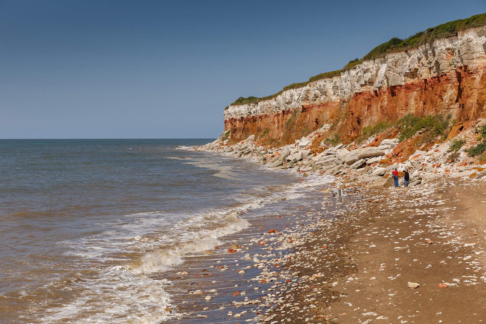 At low tide explore the rock pools against a stunning backdrop of stripy cliffs.