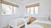 Bedroom 2 with twin beds overlooks the garden.