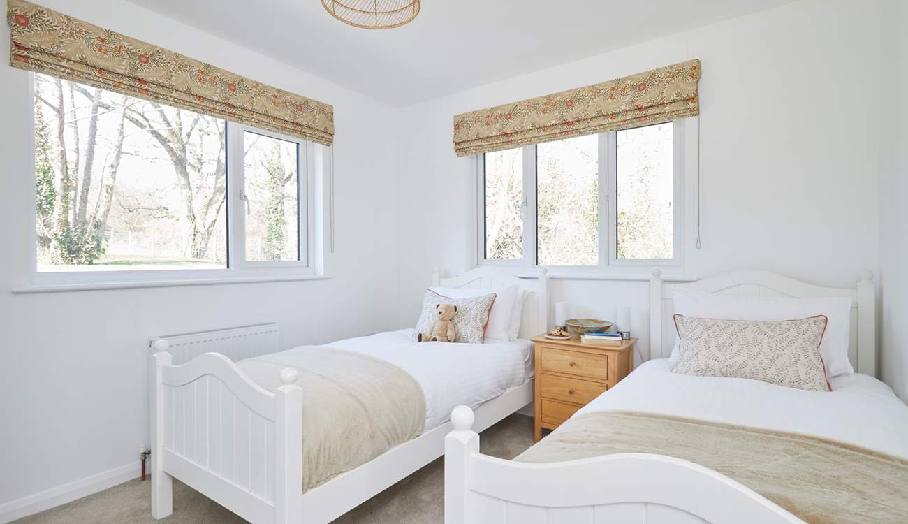 Bedroom 2 with twin beds overlooks the garden.