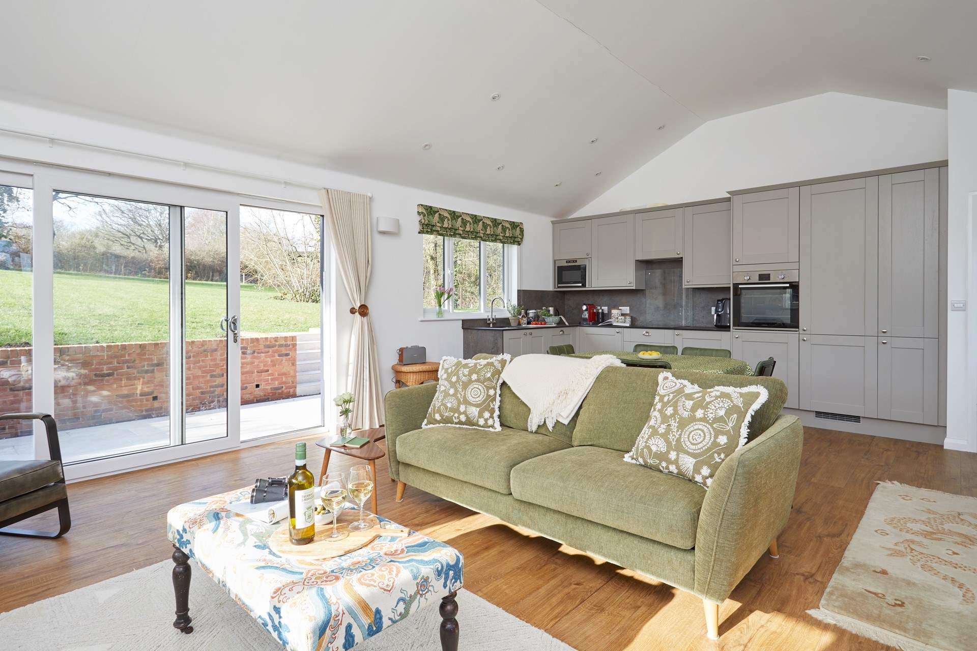 The open plan living-room with large doors leading to the garden makes this a bright and airy room.