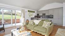 The open plan living-room with large doors leading to the garden makes this a bright and airy room.