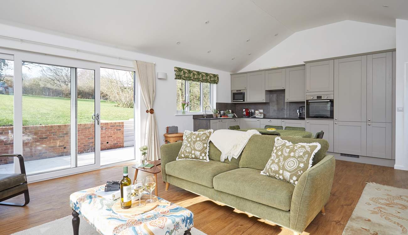 The open plan living-room with large doors leading to the garden makes this a bright and airy room.