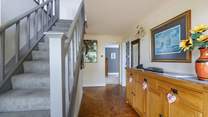 A welcoming hallway. The stairs lead to the kitchen and living areas. 