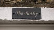 The Bothy sign on the stone façade of this pretty cottage.