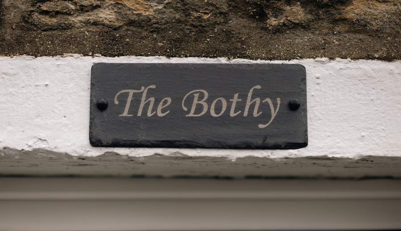 The Bothy sign on the stone façade of this pretty cottage.