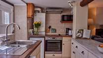 The galley kitchen is perfectly formed and has views over the garden - a real treat.