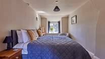 Both bedrooms are characterful and full of charm with lovely views out over the garden.
