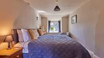 The main bedroom is very large with a sumptuous super-king size bed (which can be split into two singles) and lovely original features. Open the window and let the scents of spring and summer drift through whilst you have a well deserved lie-in.