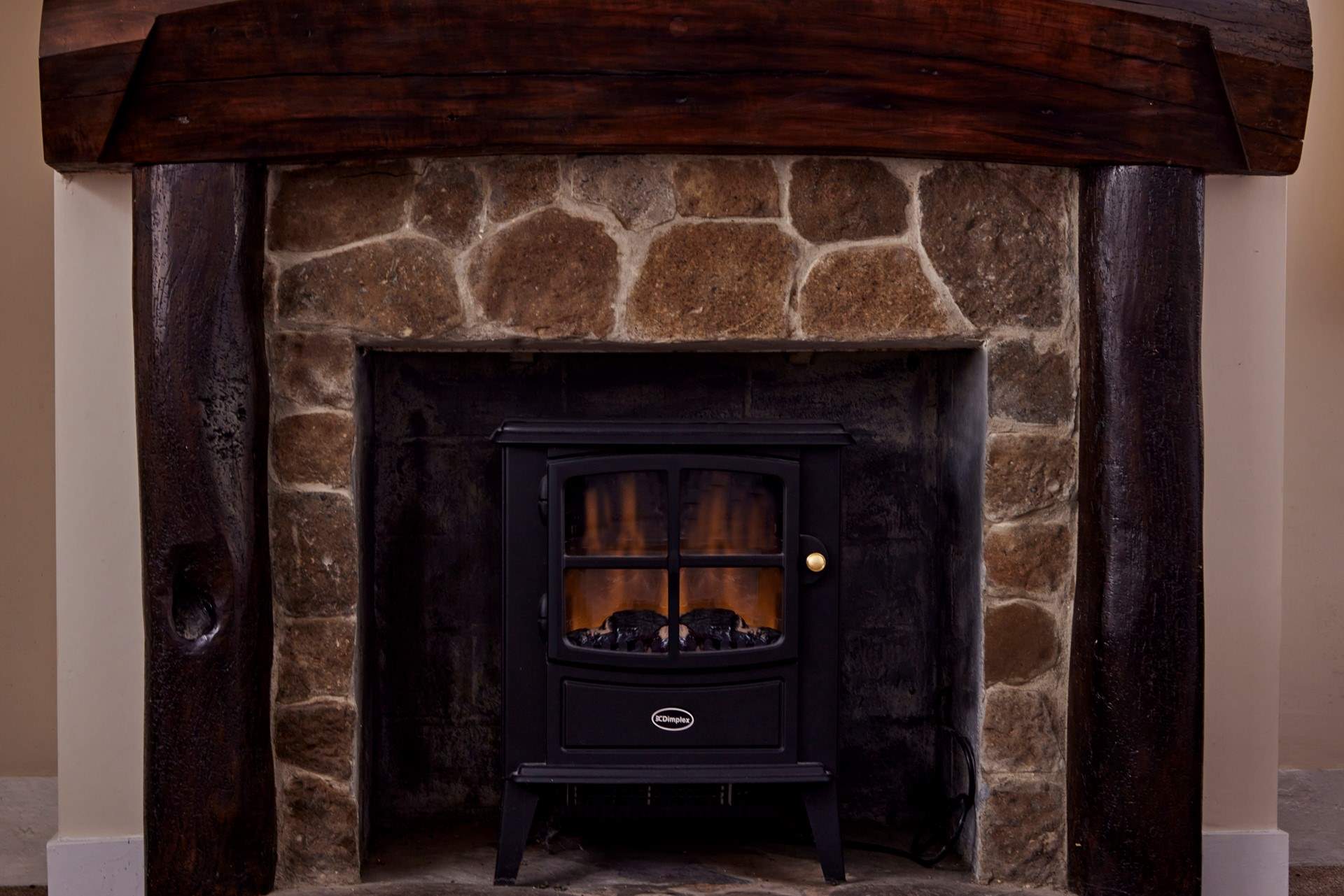 The log-effect electric fire makes the living space so cosy.