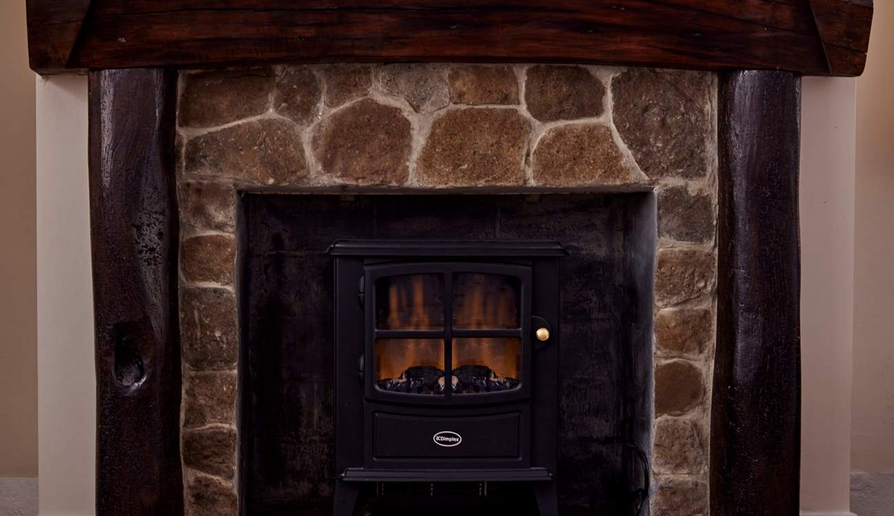 The log-effect electric fire makes the living space so cosy.