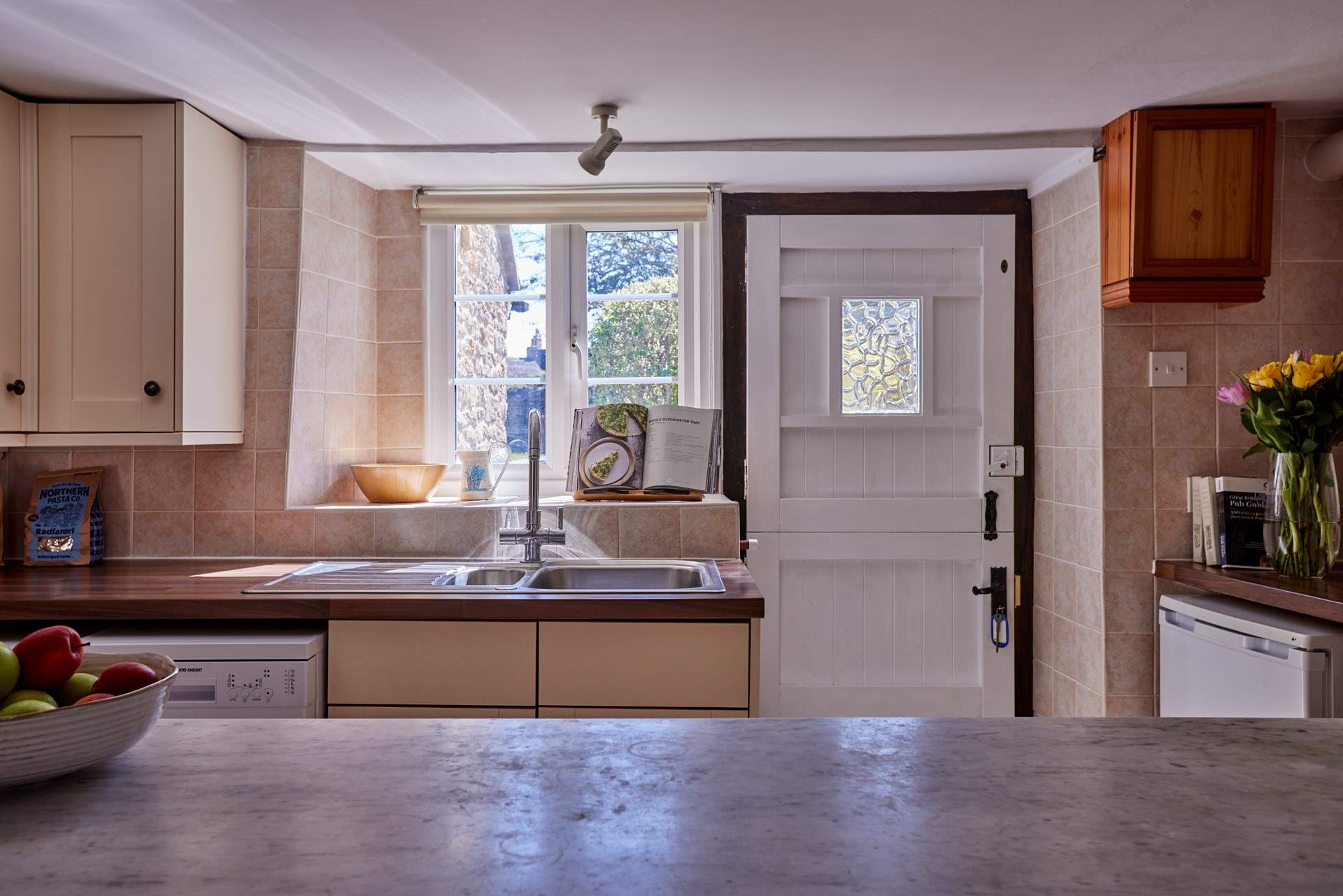 The kitchen is open to the living-room and perfect for some social cookery! It has a traditional stable-door, lots of light and glorious views over the garden.