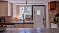 The kitchen is open to the living-room and perfect for some social cookery! It has a traditional stable-door, lots of light and glorious views over the garden.