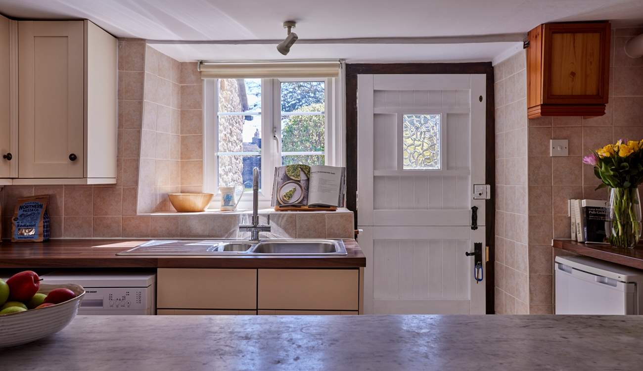 The kitchen is open to the living-room and perfect for some social cookery! It has a traditional stable-door, lots of light and glorious views over the garden.