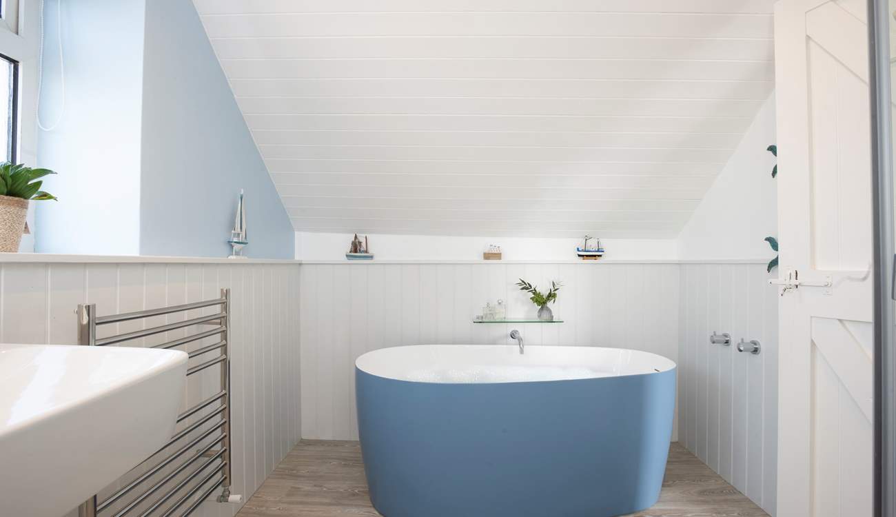 The en suite has a free-standing bath and separate shower.