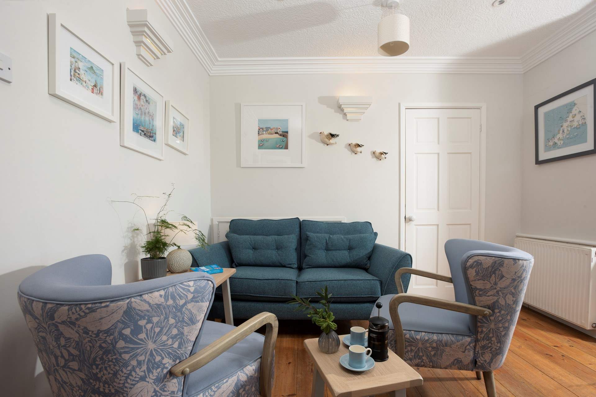 There is an additional snug area in the open plan sitting and dining-room. The door leads to the upstairs bedroom suite.