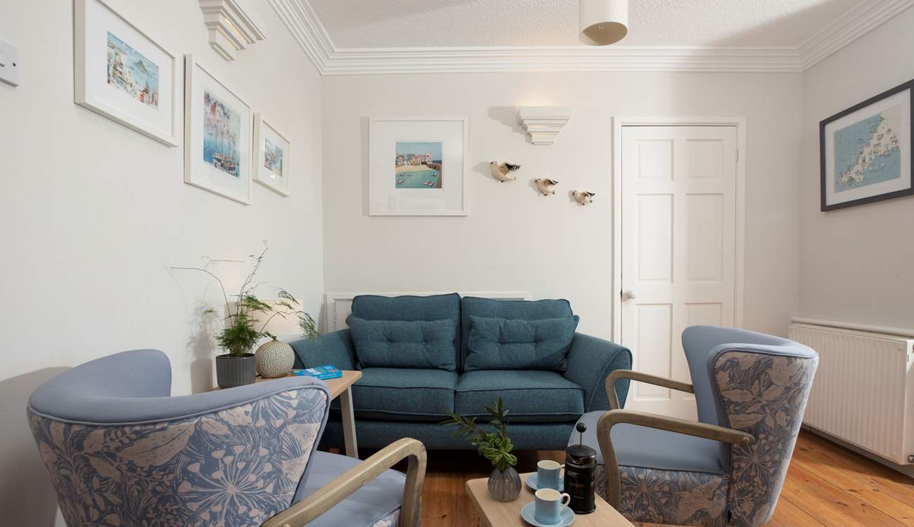 There is an additional snug area in the open plan sitting and dining-room. The door leads to the upstairs bedroom suite.