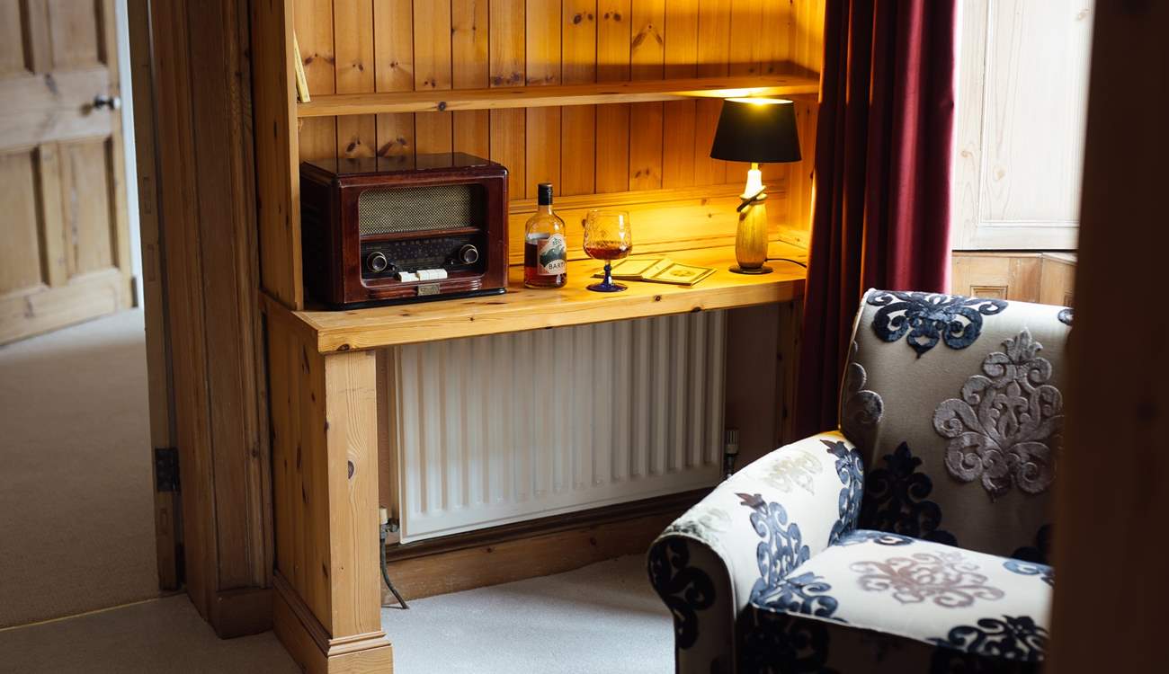 Take time out on the landing with a tipple and a good book. Look beyond the turrets across to the Clwydian Hills. 