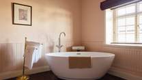Luxurious, deep bubbly bath in the family bathroom. 
