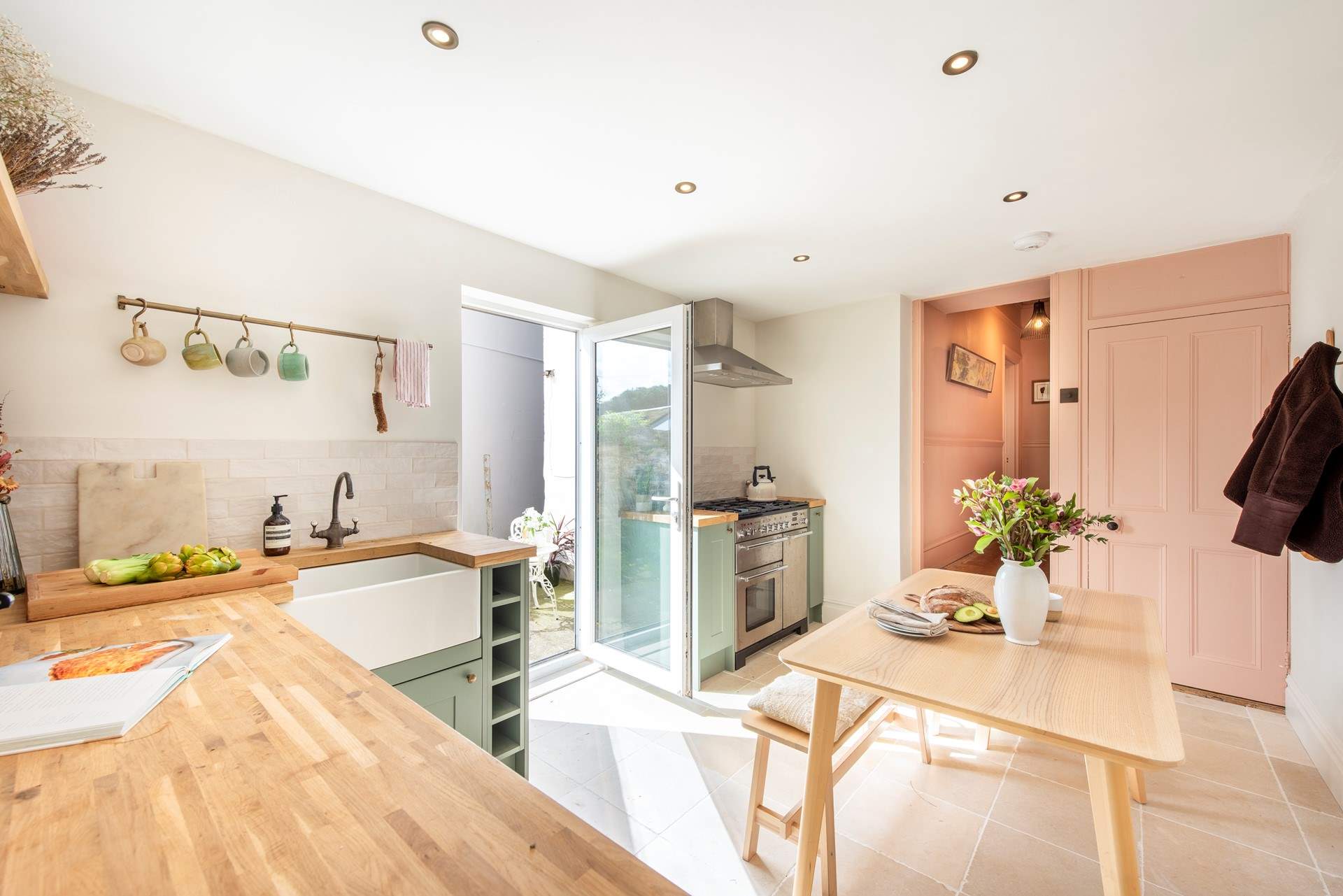 Two steps down into the kitchen from the fabulous pink hallway. 