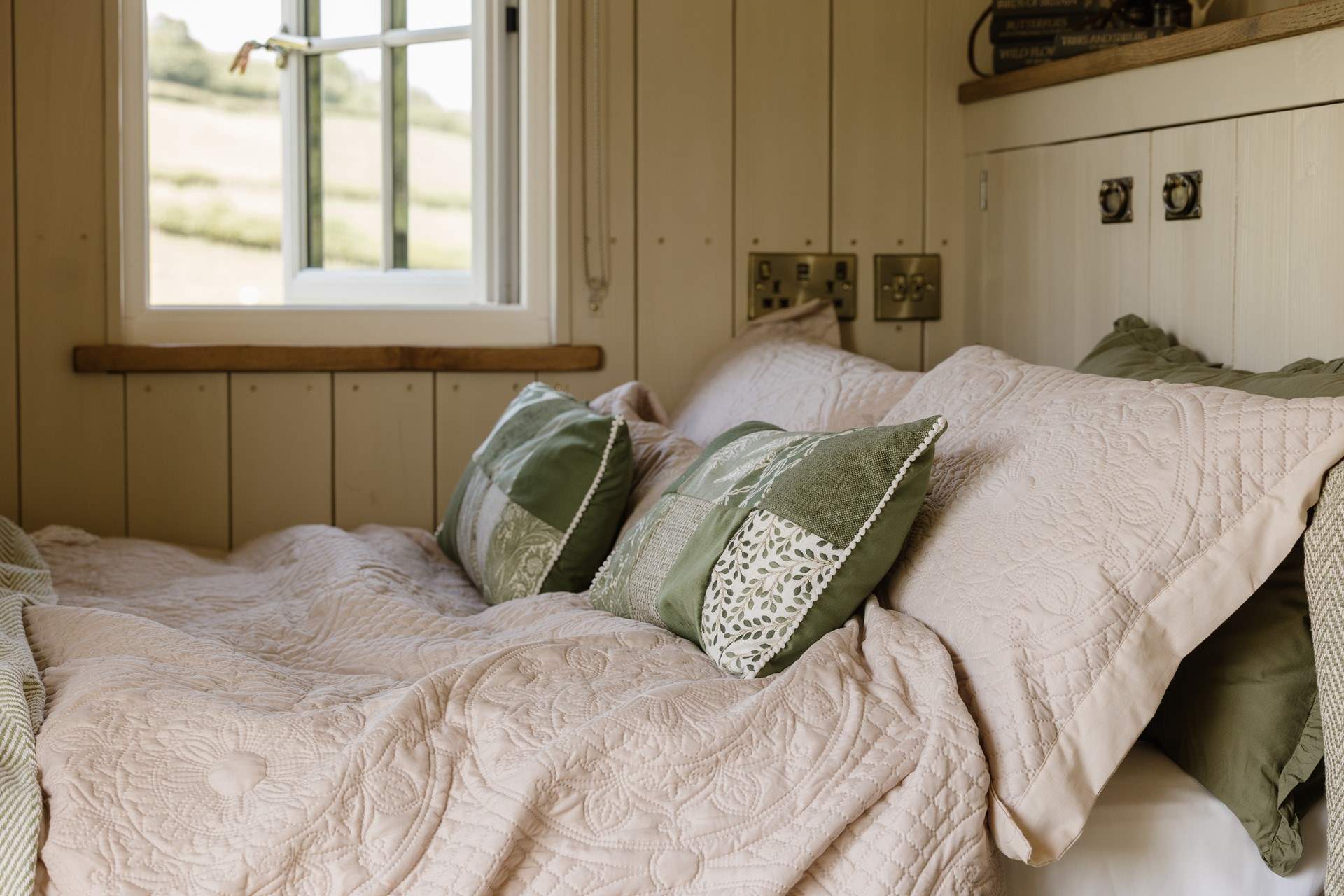 The inviting double bed promises restful nights beneath soft linens.