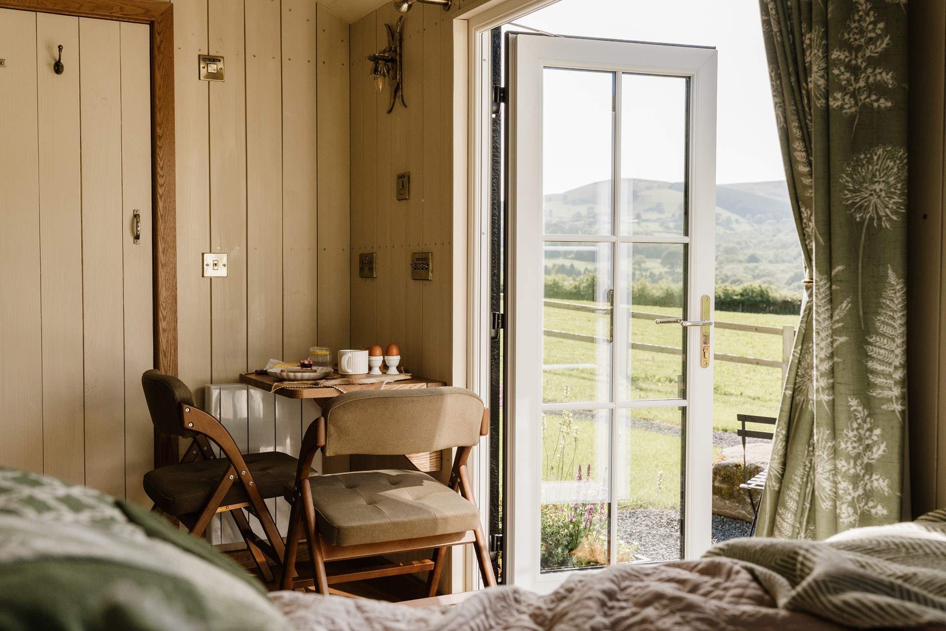 The handcrafted dining table offers a cosy setting for morning coffees and romantic meals together.
