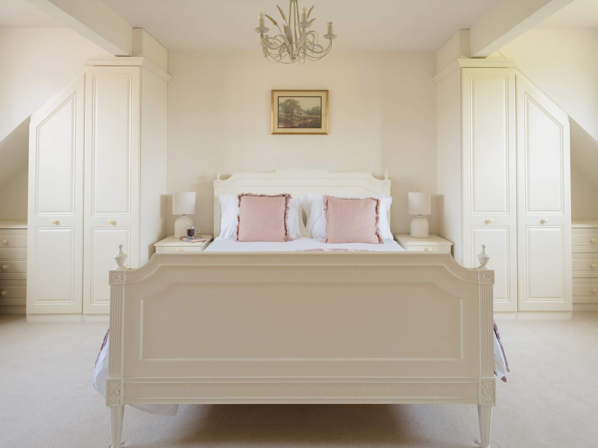 A sumptuous bedroom with twin wardrobes.