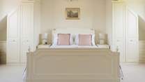 A sumptuous bedroom with twin wardrobes.